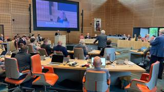 De Statenvergadering van 9 juli. Op het grote scherm staat "Renilde Huizenga – Fractievoorzitter D66.